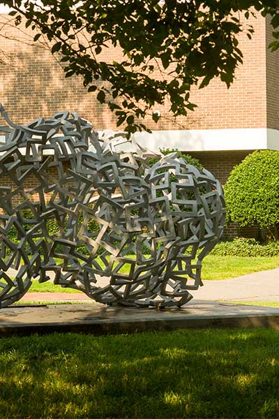 an abstract sculpture in front of Hibbs Hall on v. c. u. campus