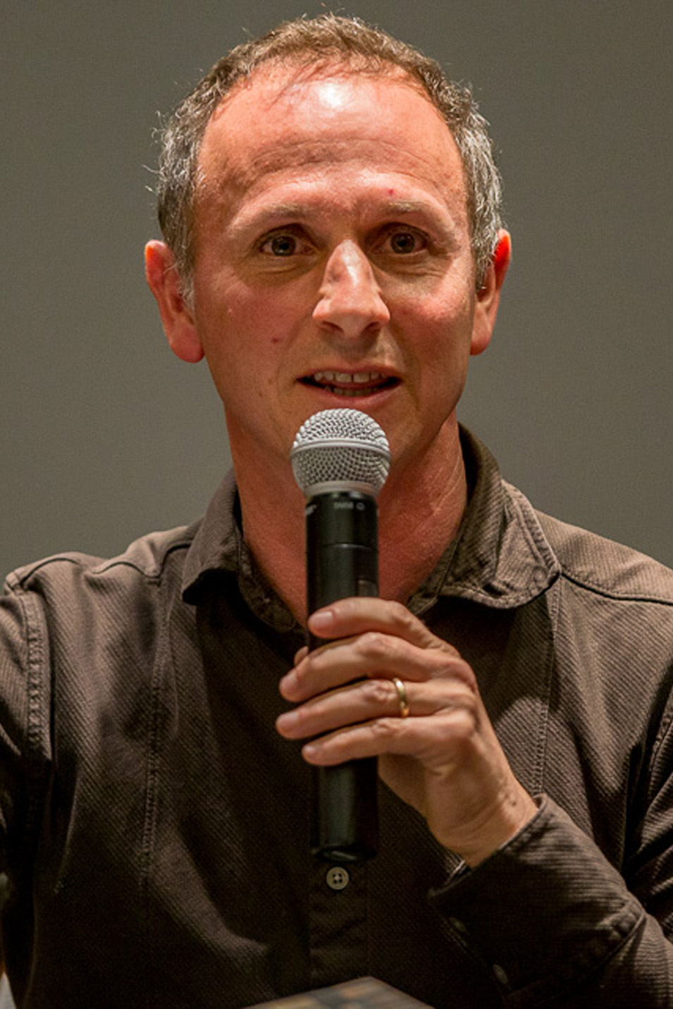 David Coogan speaks into a microphone
