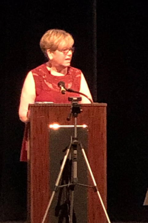 Patty Smith speaks at a podium